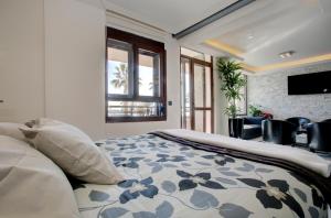 a bedroom with a bed and a tv on a wall at New Luxury Premium in Málaga