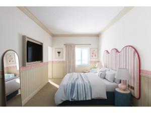 a bedroom with a large bed and a bathroom at Elysium St Mawes in Saint Mawes