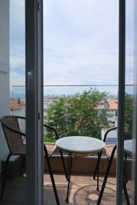 a patio with a table and chairs on a balcony at Diamond Suite in Nea Kallikrateia