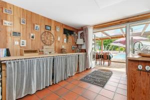 a kitchen with a long counter in a room at Gîte - Le Moulin Bernard - Béganne in Béganne
