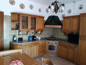 a kitchen with wooden cabinets and a stove top oven at Villa Franca in Cissano
