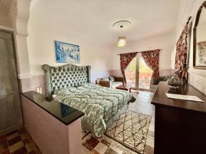 a bedroom with a bed and a sink in it at LOUIZA HOUSE, vue imprenable entre lac et désert in Lalla Takerkoust