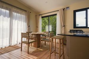 a kitchen with a table and chairs in a room at Pods at Aloe Valley, Ngobit Laikipia in Gatunga
