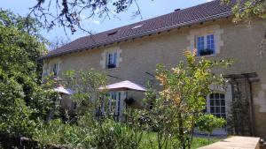 a large brick house with trees in front of it at la grange du coudert in Saint-Cybranet