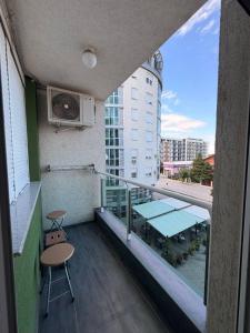 a balcony of a building with a table and chairs at Apartman Enigma II in Ruma