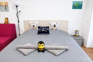 a bedroom with a bed with a smiley face in the middle at Honey Apartment in Moravske-Toplice