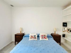 a bedroom with a blue bed with two pillows at Casa Bluende in Novo Sancti Petri +56 photos