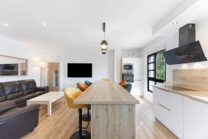 a kitchen and living room with a couch and a table at Casapoley Vejer in Vejer de la Frontera