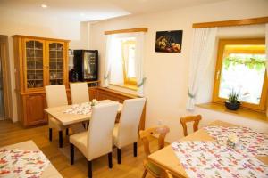 a kitchen and dining room with a table and chairs at Obst- und Weinbauernhof BERNHARD in Leutschach +27 photos