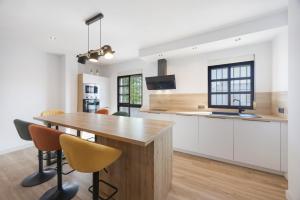 a kitchen with a wooden table and chairs at Casapoley Vejer in Vejer de la Frontera
