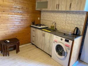 a kitchen with a washing machine and a stove at Magic Camp&Bungalow in Fethiye