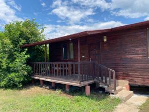 a wooden house with a porch on the side of it at Magic Camp&Bungalow in Fethiye