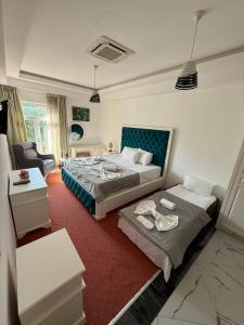 a bedroom with a bed and a living room at Diamond Hotel & Restaurant Ulcinj in Ulcinj