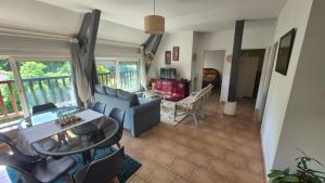 a living room with a couch and a table at Biloba in Saint-Paul-lès-Dax
