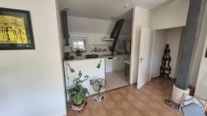 a kitchen with a fan in the middle of a room at Biloba in Saint-Paul-lès-Dax