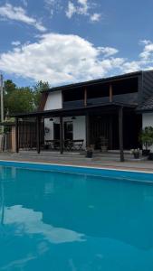 a house with a swimming pool in front of it at Хутір Hall in Radisne