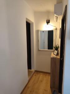 a room with a hallway with a mirror and a table at Apartment Miljenko Tomic 2 in Supetar +6 photos