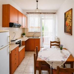 a kitchen with a table and a dining room at Sunset Apartments in Missolonghi +7 photos