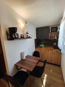 a small kitchen with a wooden table and chairs at Apartment Miljenko Tomic 2 in Supetar