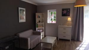 a living room with a couch and a chair at la grange du coudert in Saint-Cybranet +3 photos