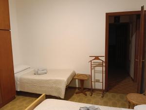 a room with two beds and a table and a door at Villa Franca in Cissano