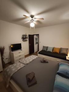a bedroom with a bed and a ceiling fan at Apartment Miljenko Tomic 2 in Supetar