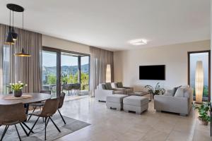 a living room with a couch and a table at Linde Villas in Maria Wörth