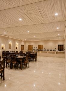 a large dining room with wooden tables and chairs at Jaisalmer Villa Resort & Camp Jaisalmer in Jaisalmer