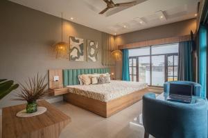 a bedroom with a bed and a tv and a couch at River View Resort in Haridwār