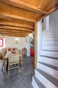 a kitchen and dining room with a table and stairs at Marketos Traditional Windmill in Tripiti +24 photos