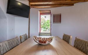 a bowl of fruit sitting on top of a wooden table at Marketos Traditional Windmill in Tripiti