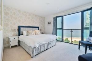 a bedroom with a bed and a view of the ocean at Porthminster Mews 2 in St Ives