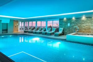 a pool in a hotel with chairs and a spa at Porthminster Mews 2 in St Ives +20 photos