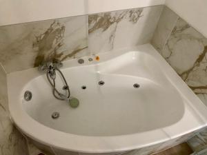 a white bath tub in a bathroom with marble at Studio vieille porte in Hombourg-Haut +9 photos