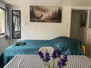 a bedroom with a bed and a picture of a deer at Studio vieille porte in Hombourg-Haut