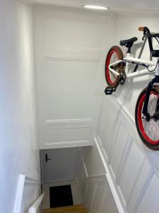 a bike hanging on a wall next to a staircase at Studio vieille porte in Hombourg-Haut