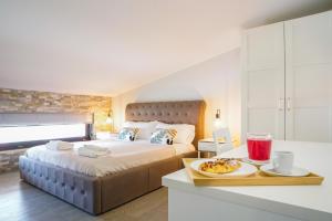 a hotel room with a bed and a tray of food at Pietra Bianca Rooms in Pachino