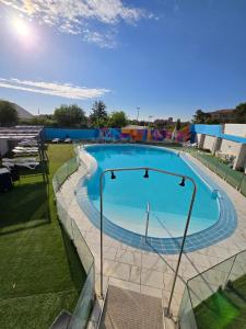 a large swimming pool with a fence around it at Hotel Bardo Recoletos Coco in Salamanca