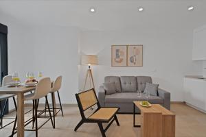 a living room with a couch and a table at GAV Nueva Quince in Ronda
