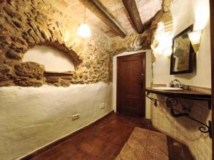 a bathroom with a stone wall and a sink at Casa historica en Corçà, Baix Empordà in Corçà +54 photos