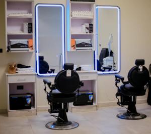 a salon with two mirrors and two chairs at Moorland House & Spa in Migori