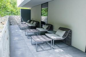 a row of chairs and tables on a patio at Hotel Ráztoka in Trojanovice