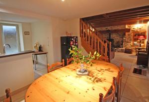 a wooden table with a vase on it in a kitchen at La petite ecosse in Châteauneuf-la-Forêt +24 photos