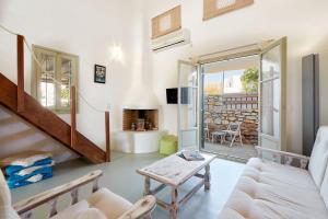 a living room with a couch and a table at Villa Joy in Aliki