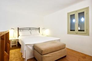 a bedroom with a white bed and a window at Villa Joy in Aliki +48 photos