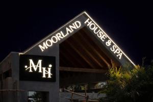 a sign that says mx on a building at night at Moorland House & Spa in Migori