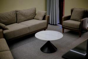 a living room with a couch and a table at Moorland House & Spa in Migori