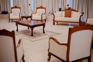 a living room with chairs and a coffee table at Moorland House & Spa in Migori