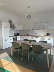 a kitchen with a wooden table and chairs in it at Ferienwohung in Maissau in Maissau