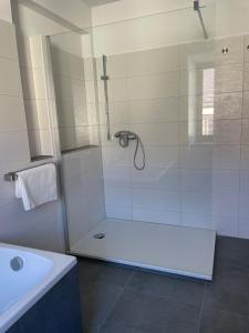 a white bathroom with a shower and a sink at Ferienwohung in Maissau in Maissau